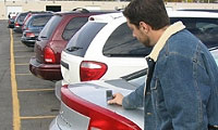 Misurazione del rivestimenti di una valvola posteriore di un' automobile con il spessimetro.